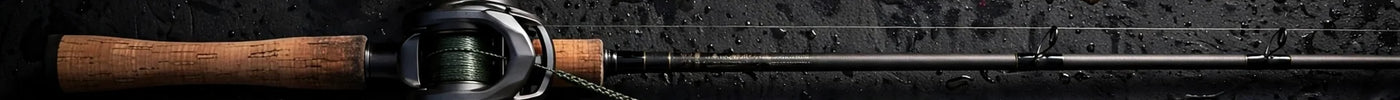Tackle flat-lay: baitcasting rod, stick worms, wacky hooks, O-rings and weights on a dark boat deck