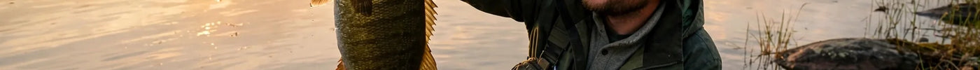 Angler holding a smallmouth bass at golden hour on an Ontario lake